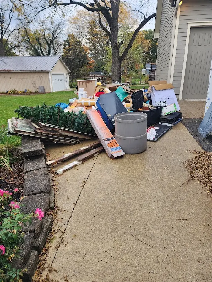 Dumpster being loaded with debris for Residential Dumpster Rental in Oakville